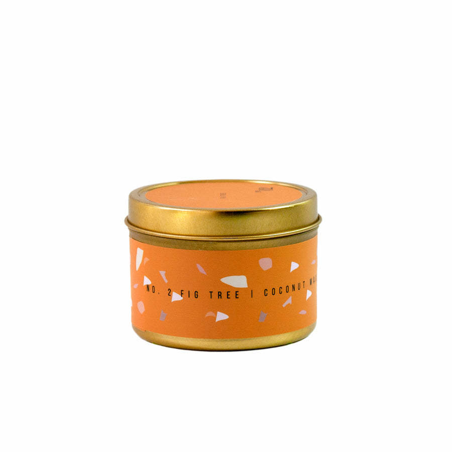 Orange fig scented mini candle in gold tin can.